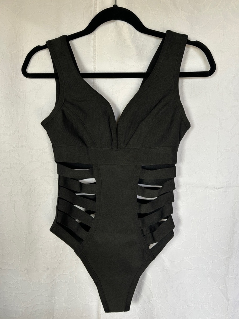 WOW COUTURE World of Women Black swim suit. Straps on sides. Size Small.